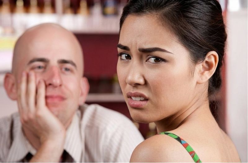 A woman looking let down on yet another disappointing date